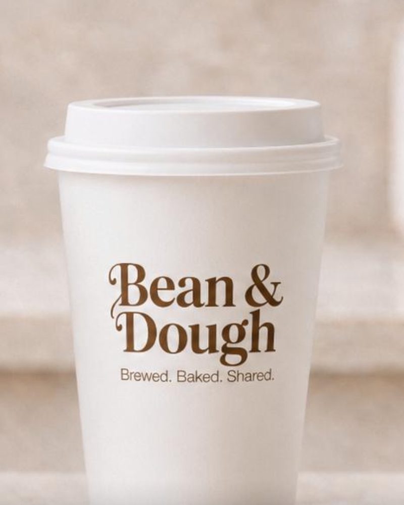 Bean & Dough hot coffee in a branded takeaway cup